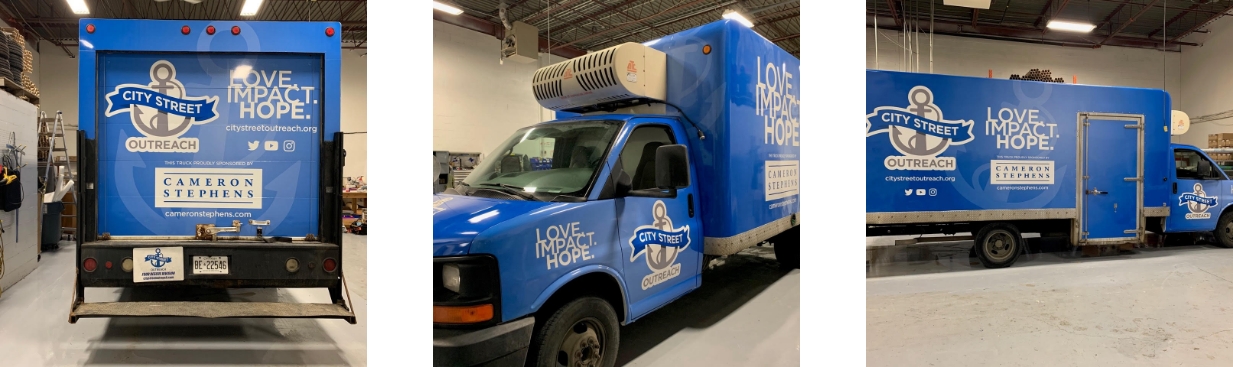 Three perspectives of a blue City Street Outreach truck with the words Love, Impact, Hope written in on it, as well as the Cameron Stephens' logo based on their sponsorship of this initiative.